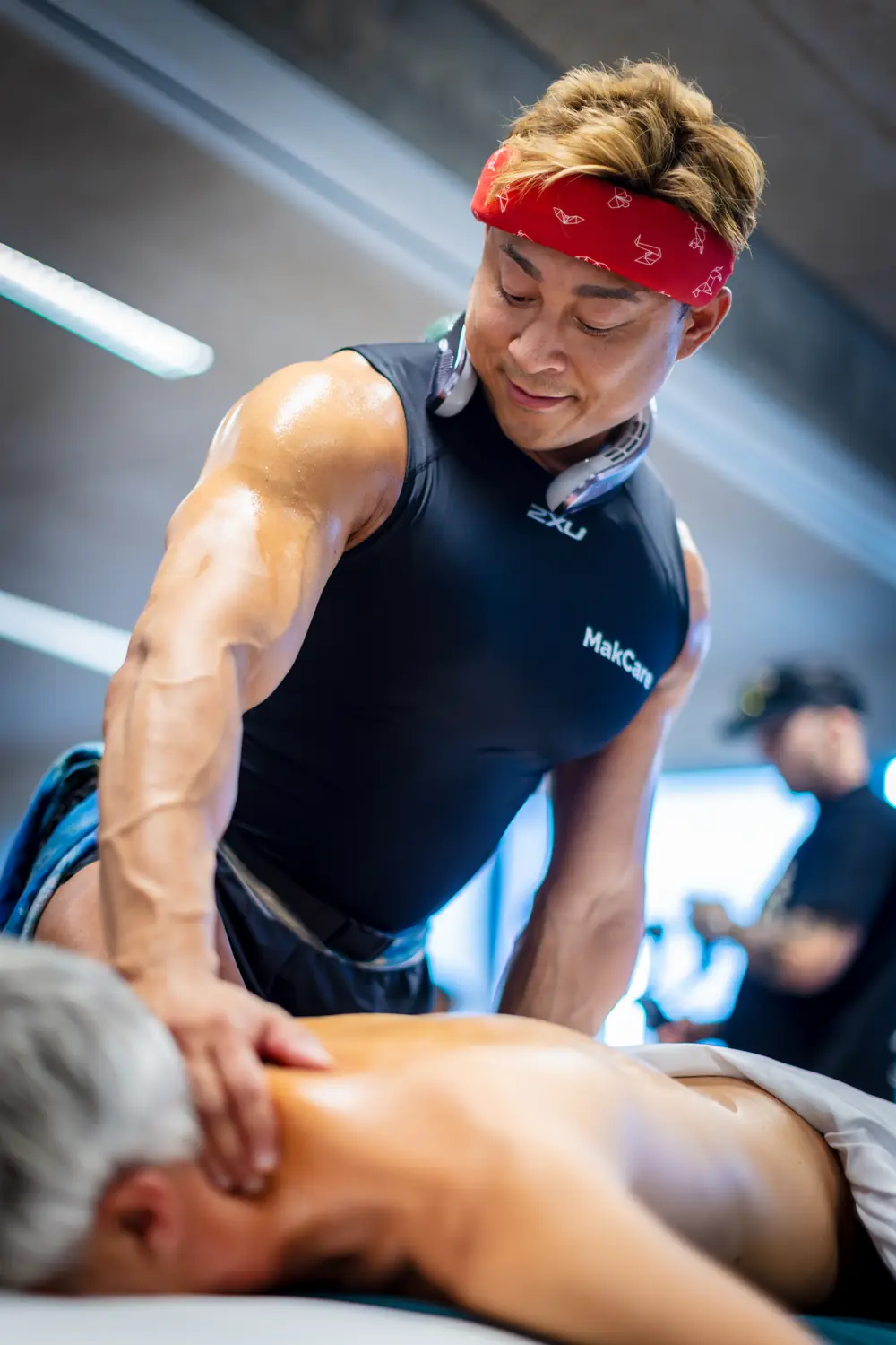 Hubert Mak working on a client's shoulders