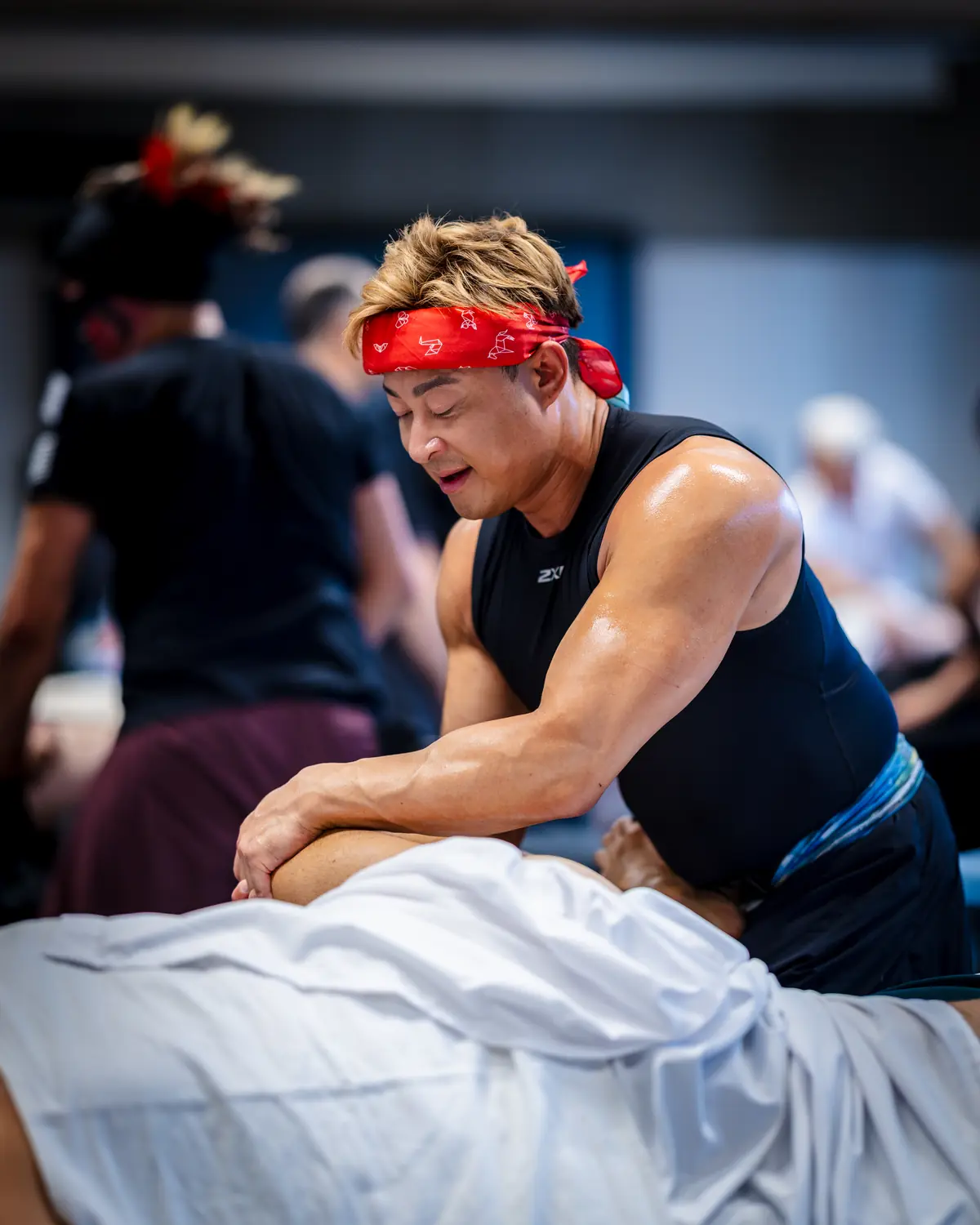 Hubert Mak focused on a treatment at the table